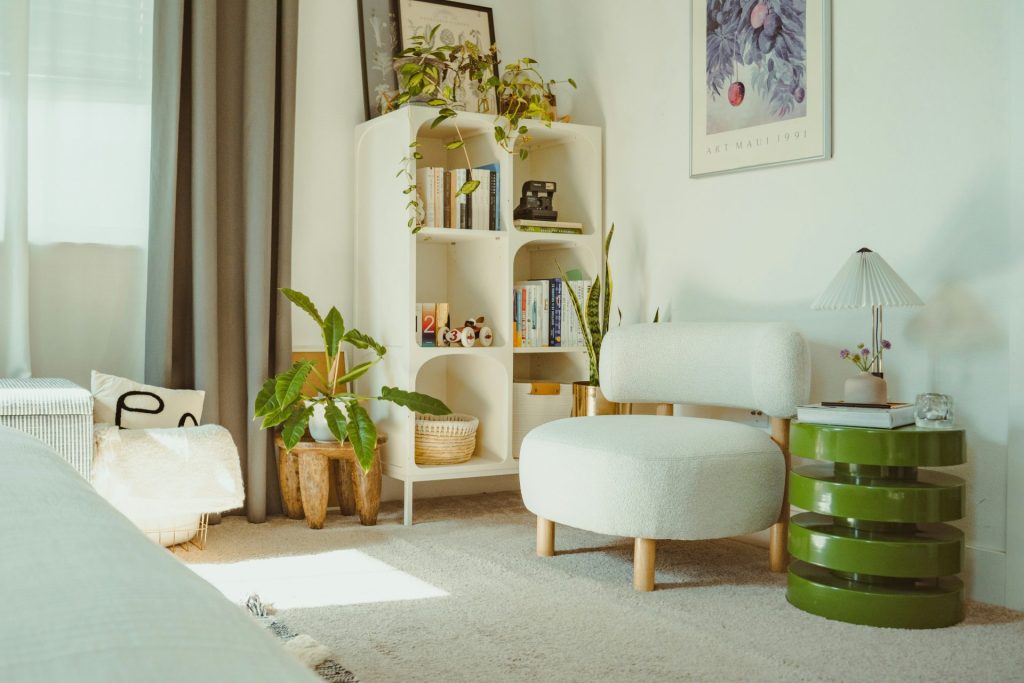 Bright, cozy room with plants and a white chair.